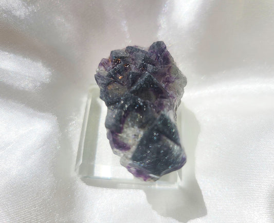 Rare Cubic Fluorite Specimen with Rutile inclusions on glass stand 02